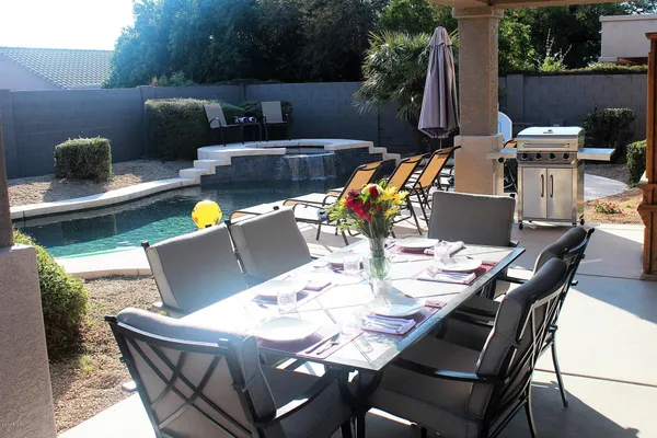 a view of a dining table and chairs in the patio