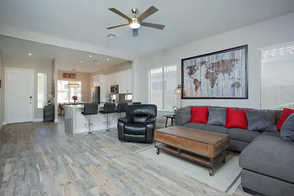 a living room with furniture and kitchen view