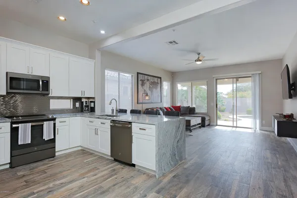 a kitchen with sink stove and cabinets
