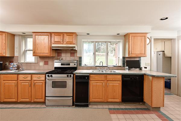 284 Pond Street Boston, MA 02130 - Photo 12 of 27 a kitchen with stainless steel appliances granite countertop a stove a sink and a microwave