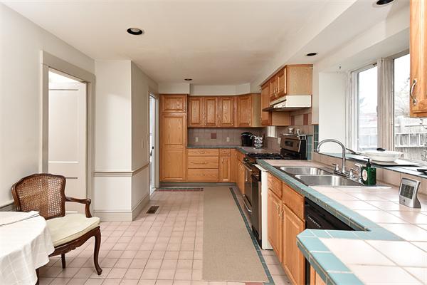284 Pond Street Boston, MA 02130 - Photo 10 of 27 a kitchen with a sink a counter top space a large window and stainless steel appliances