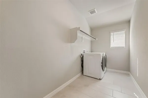 a utility room with a sink a washer and dryer