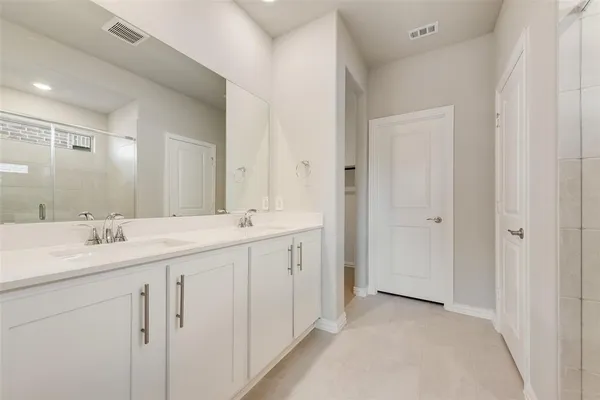 a bathroom with a double vanity sink and mirror