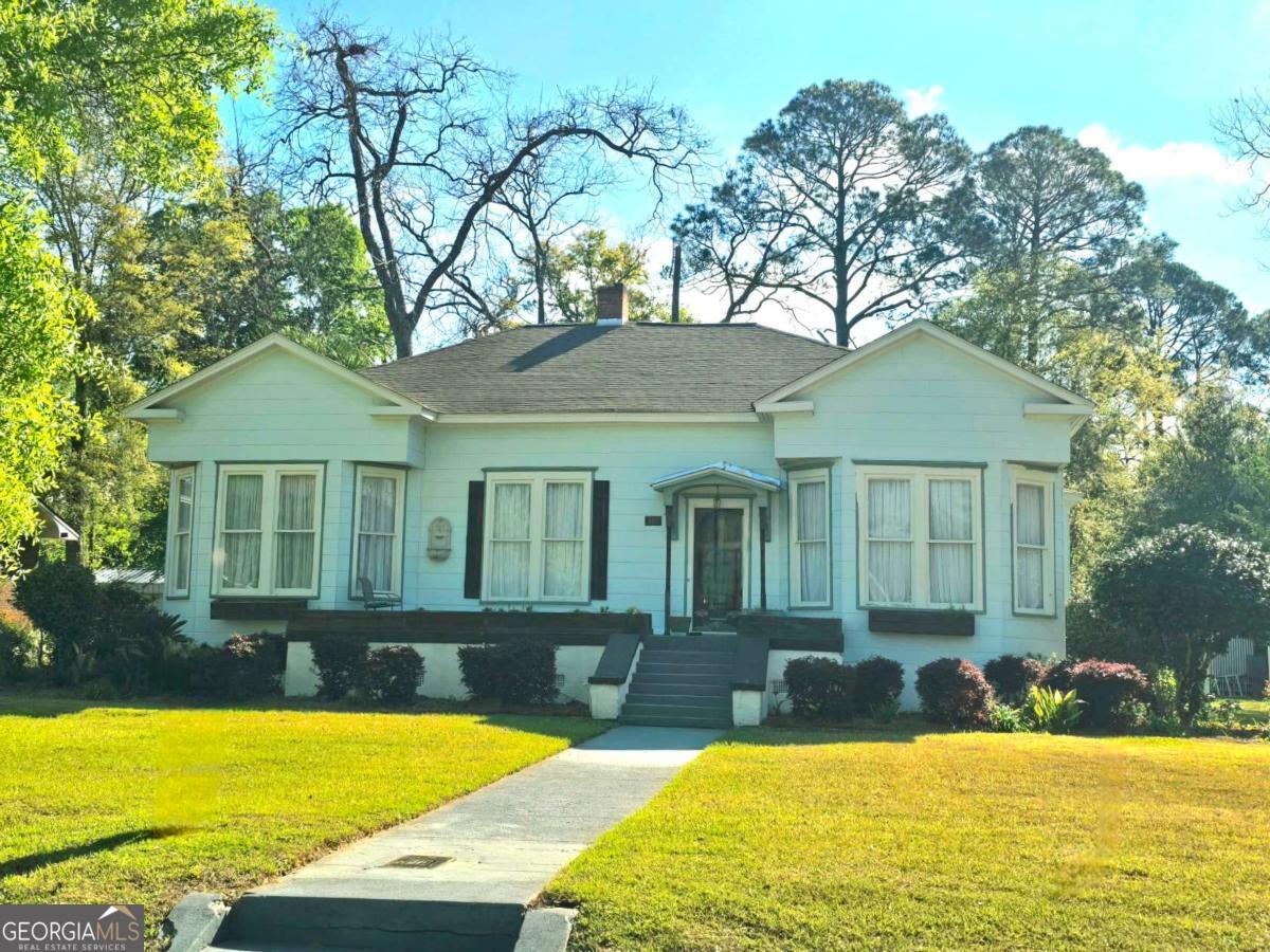 a view of a house with swimming pool and porch with furniture