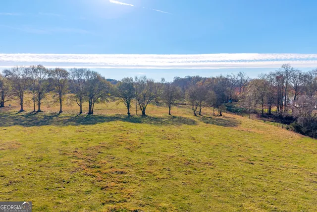 a view of a house with swimming pool and sitting area
