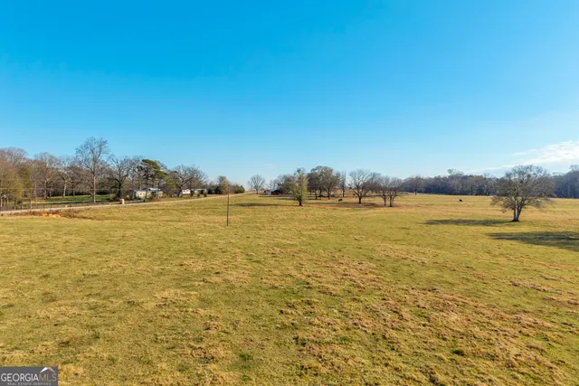 a wooden bench sitting in middle of a yard
