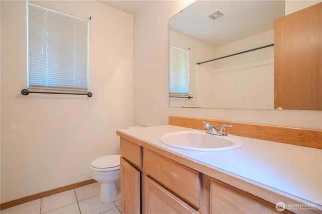 a bathroom with a sink a toilet and mirror