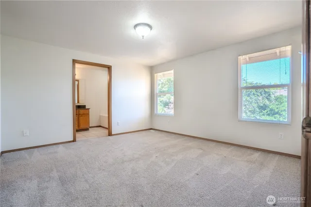 an empty room with windows and closet