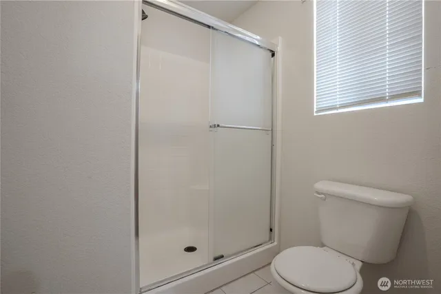 a white toilet sitting next to a bathroom sink