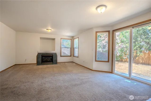 an empty room with floor to ceiling window and an empty room