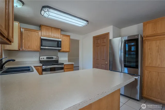 a kitchen with stainless steel appliances a sink a stove and a refrigerator