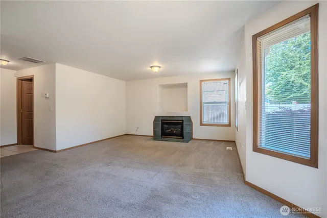 an empty room with furniture and a fireplace