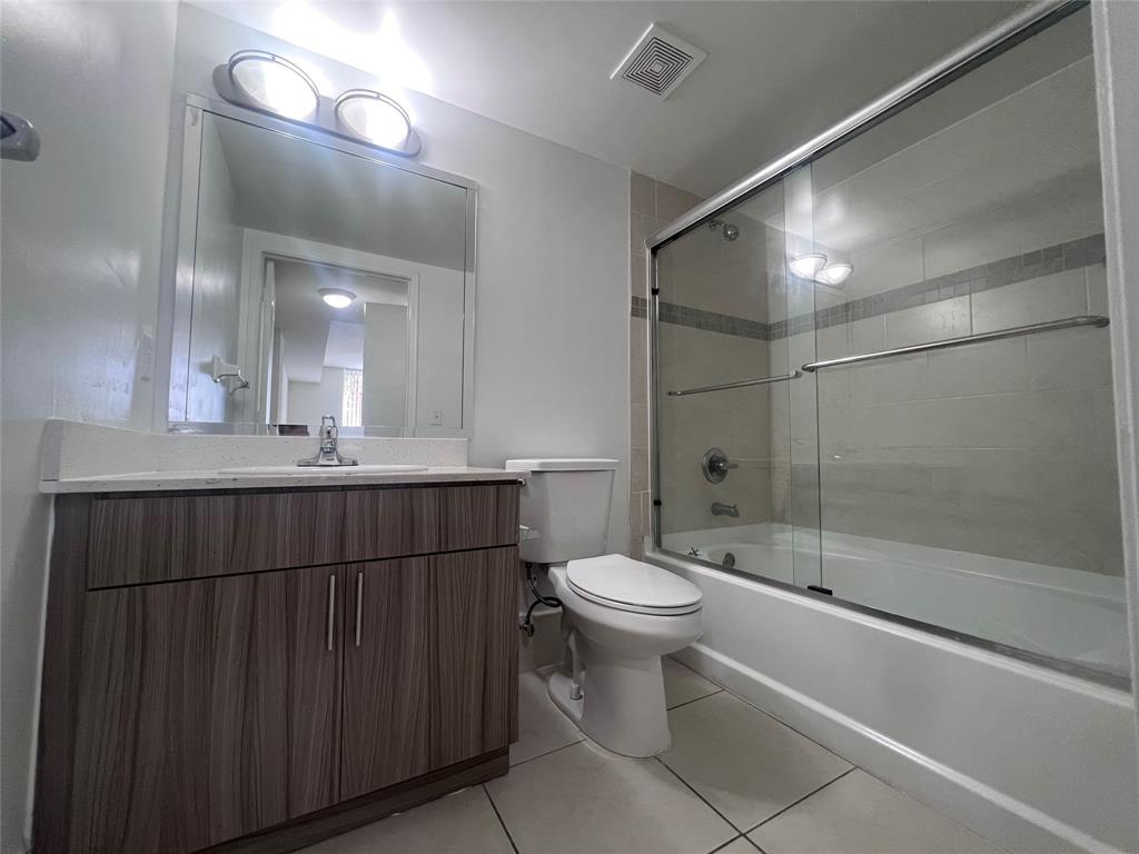 18335 Northwest 68th Avenue, Unit 255308 Hialeah, FL 33015 - Photo 7 of 17 a bathroom with a sink a toilet and shower
