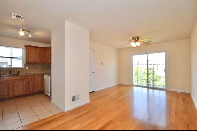 a view of a kitchen with a sink and dishwasher wooden floor