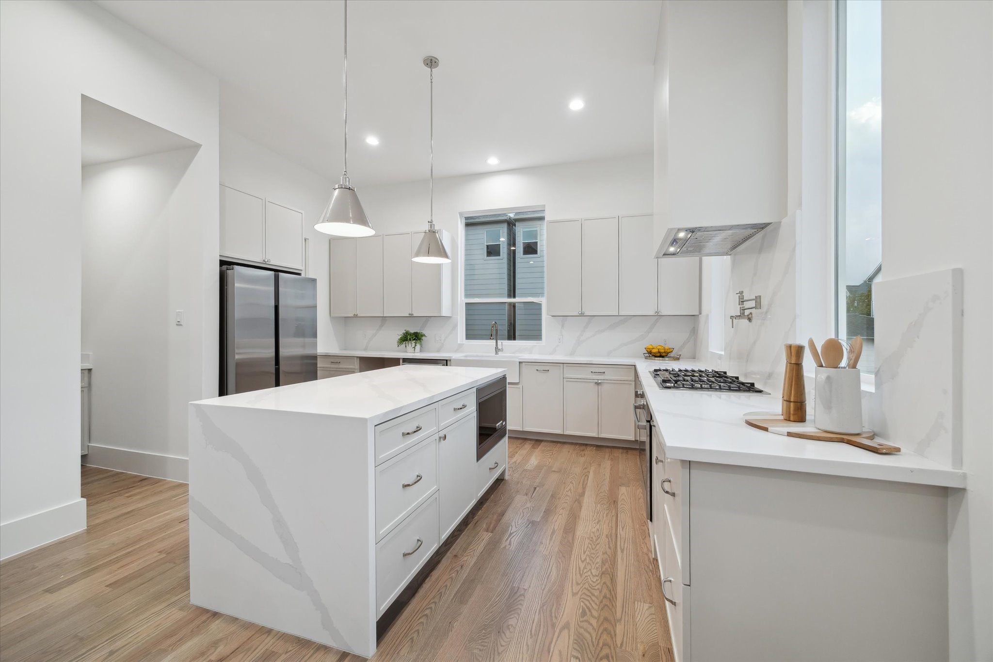 4229 Gibson Street Houston, TX 77007 - Photo 3 of 26 You'll find handcrafted 1" shaker style soft close cabinets, Calacatta Quartz counters extended to backsplash and waterfall island detail.