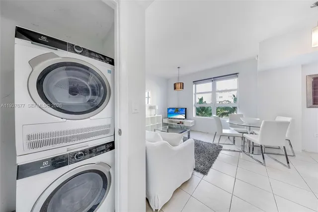 a view of a living room and washer and dryer