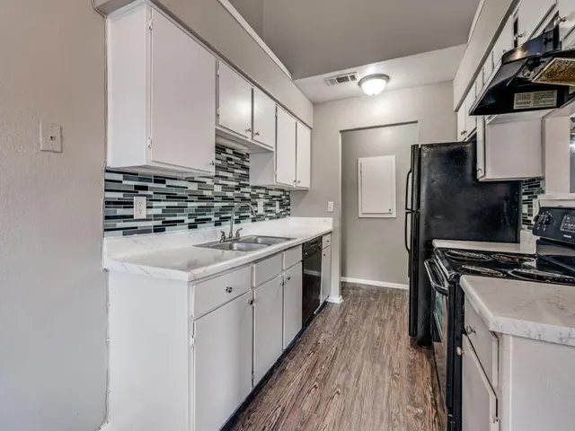 a kitchen with stainless steel appliances a sink stove and refrigerator
