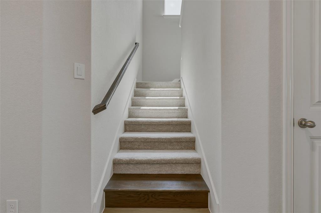 1337 Frio Drive Springtown, TX 76082 - Photo 14 of 40 Staircase with carpeted treads, wood-finish risers, and a dark wood handrail