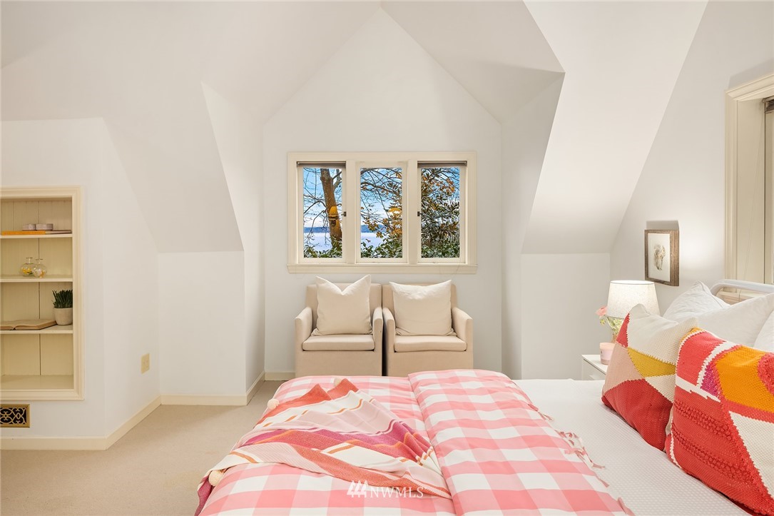 4706 West Ruffner Street Seattle, WA 98199 - Photo 21 of 27 a bedroom with a bed and a chair