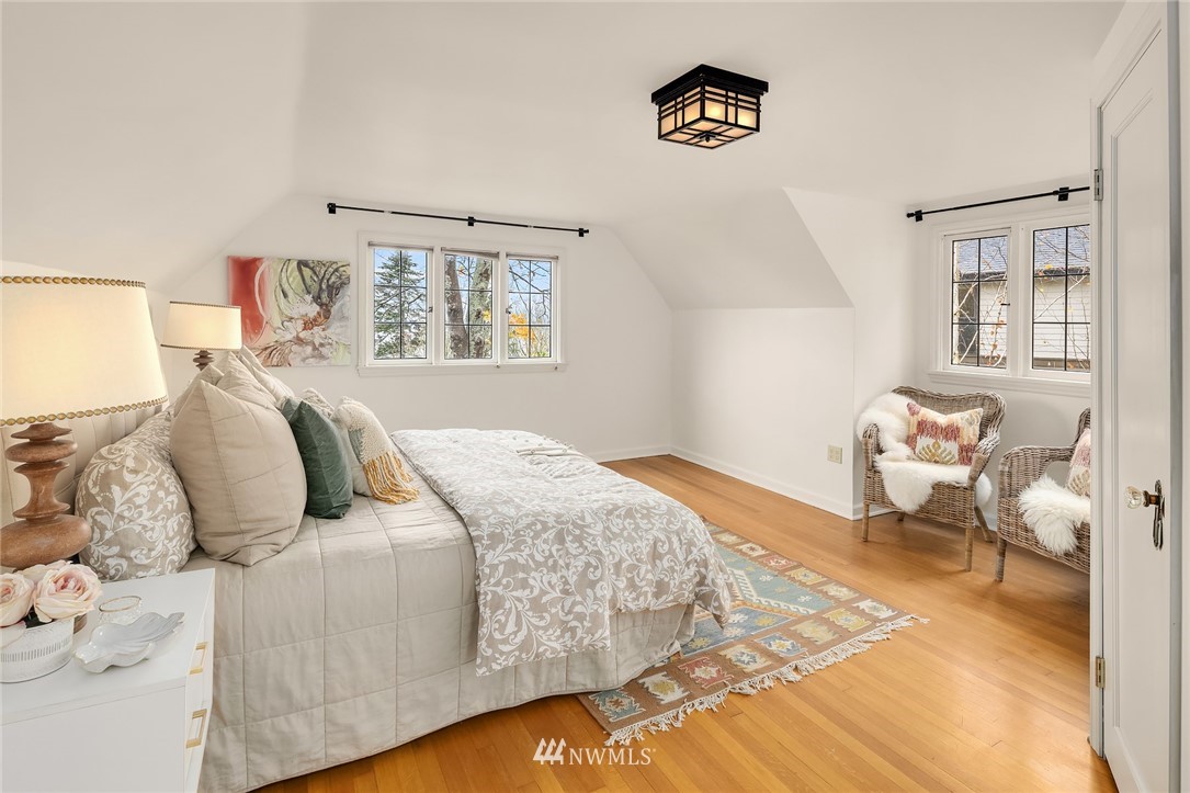 4706 West Ruffner Street Seattle, WA 98199 - Photo 23 of 27 a bedroom with a bed and wooden floor