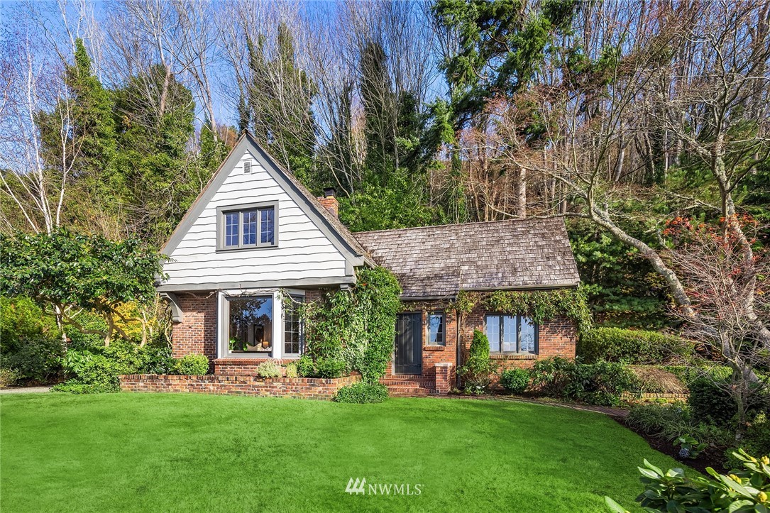 4706 West Ruffner Street Seattle, WA 98199 - Photo 26 of 27 a front view of a house with a garden and porch