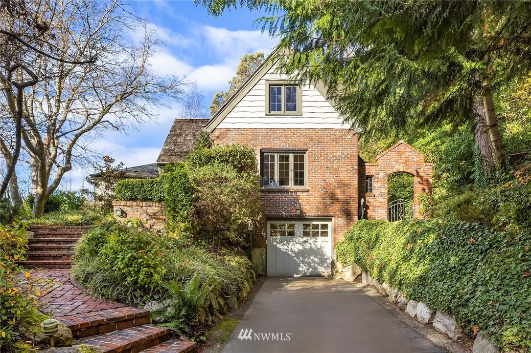 4706 West Ruffner Street Seattle, WA 98199 - Photo 8 of 27 a view of a white house next to a road and trees