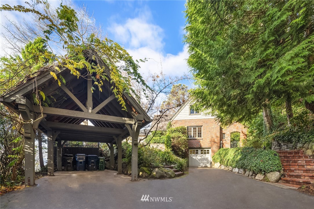 4706 West Ruffner Street Seattle, WA 98199 - Photo 9 of 27 a view of a patio with table and chairs and a large tree