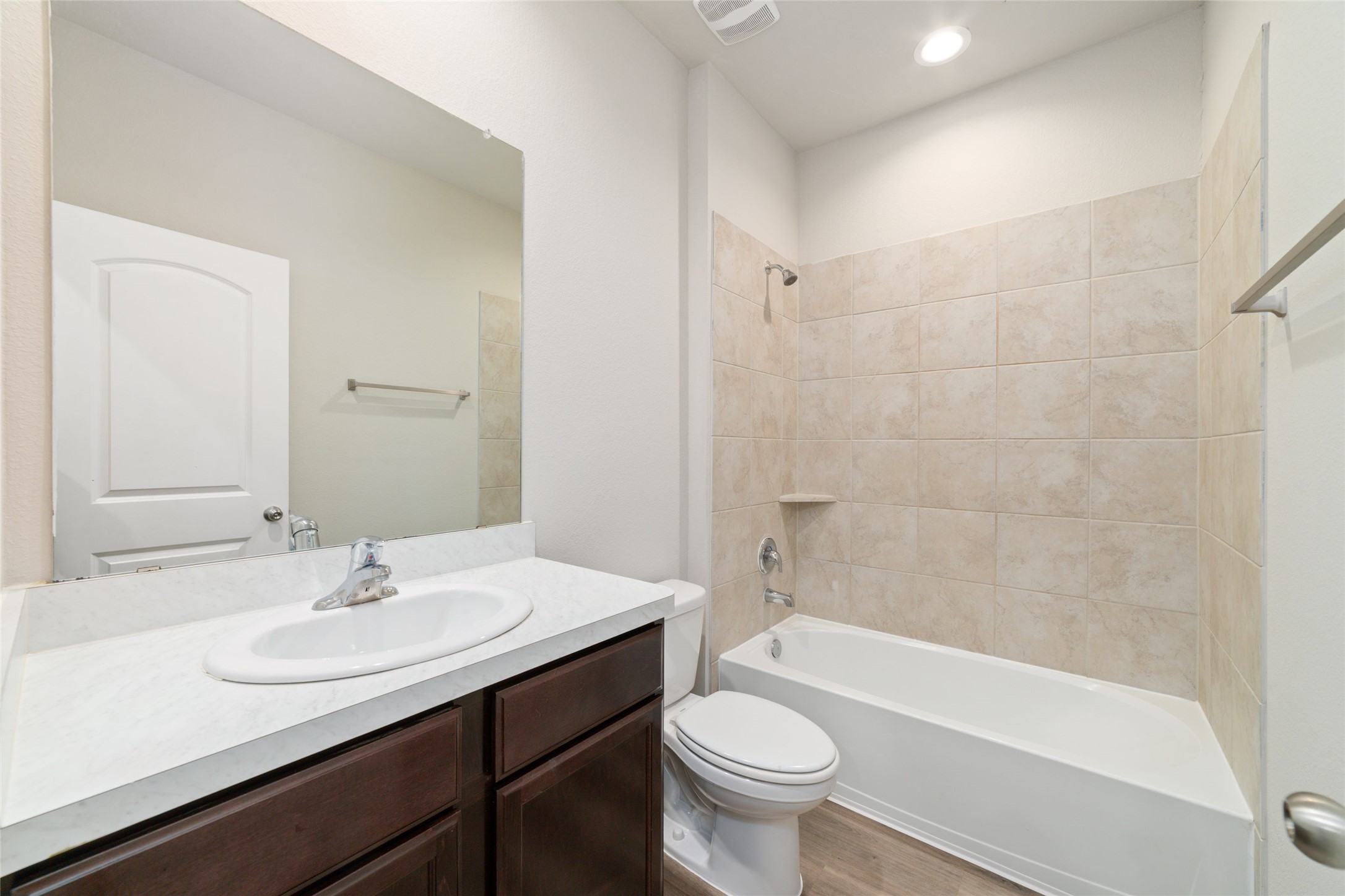 23702 Harrow Field Ln Spring Spring, TX 77373 - Photo 23 of 32 a bathroom with a sink a toilet a mirror a bathtub and shower