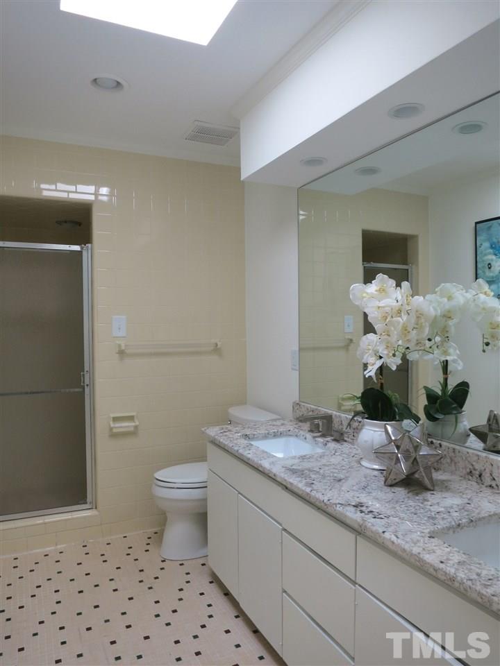 600 Davidson Street Raleigh, NC 27609 - Photo 14 of 25 The updated Master Bath has a w/granite vanity top, 2 rectangular sinks, tile floor & lg tiled shower.