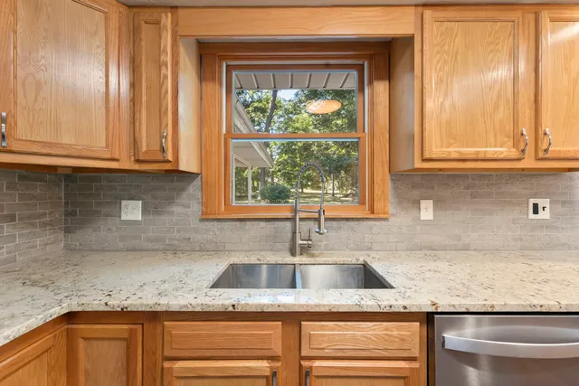 a kitchen with granite countertop a sink and a window
