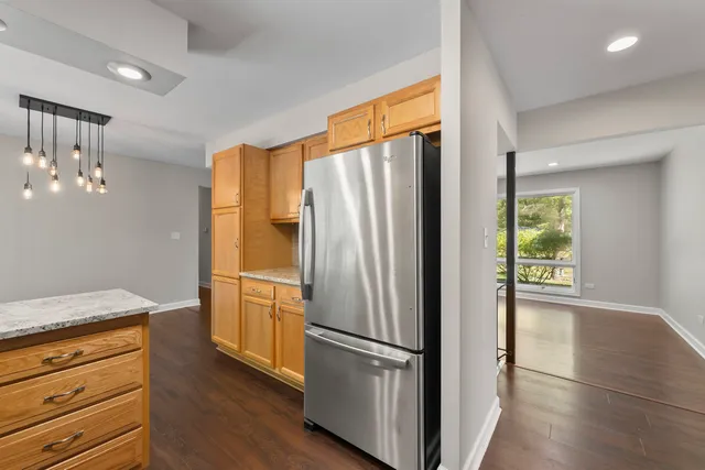 a kitchen with stainless steel appliances a refrigerator and a stove top oven