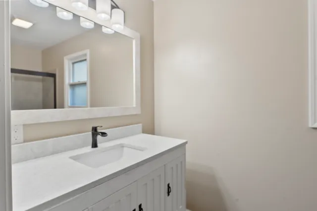 a bathroom with a sink and a mirror