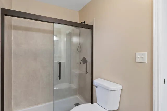 a bathroom with a shower and a toilet