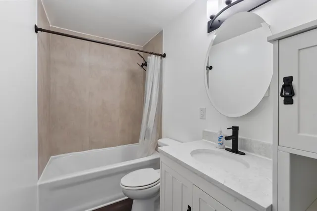 a bathroom with a sink toilet and a mirror