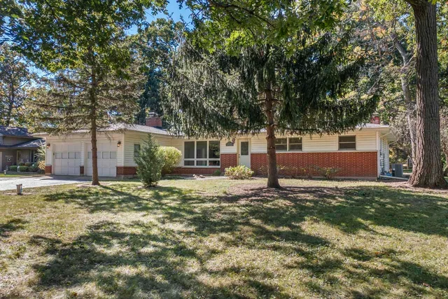 a backyard of a house with outdoor seating