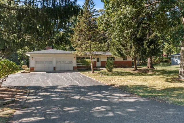 a view of a patio with table and chairs under an umbrella