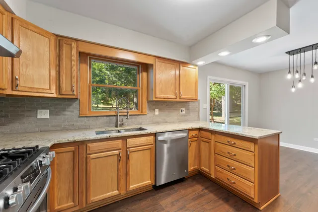 a kitchen with a sink stove and cabinets