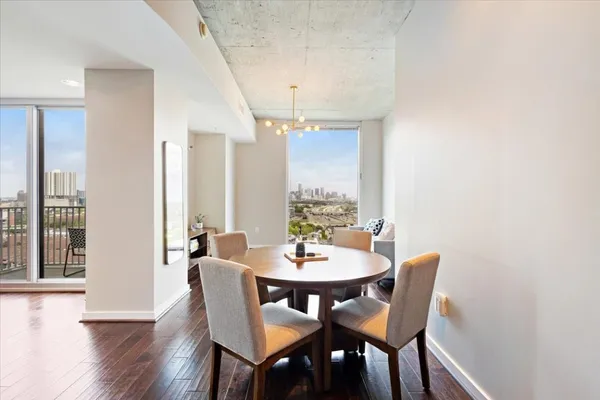 a view of a dining room with furniture and wooden floor