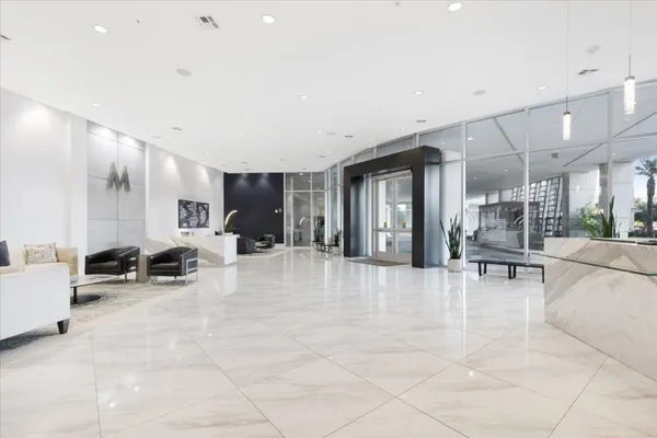 a view of a living room kitchen and a chandelier