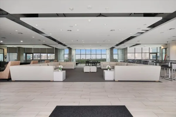 a living room with couches and kitchen view