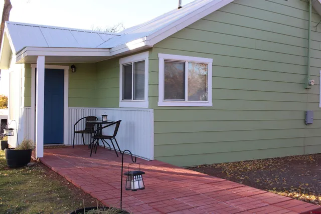 a view of a balcony with furniture and front door
