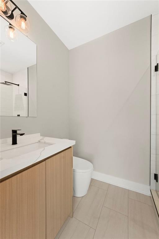 7066 Bells Way Fairburn, GA 30213 - Photo 46 of 64 a bathroom with a sink a toilet and a mirror