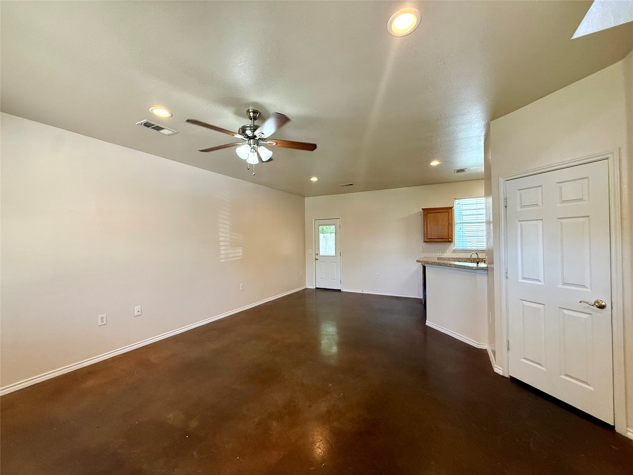 6912 Meador Avenue, Unit A Austin, TX 78752 - Photo 2 of 24 en view of an empty room with a kitchen