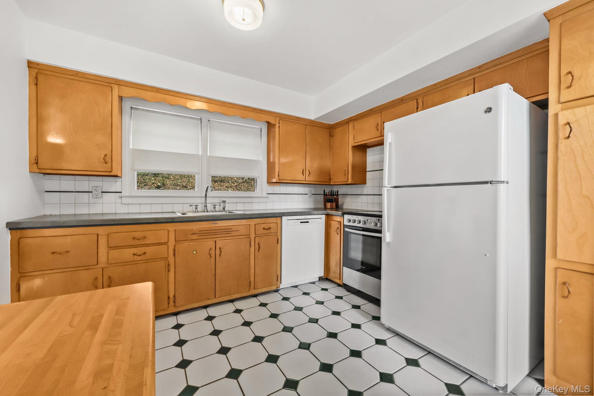 150 Rosedale Avenue White Plains, NY 10605 - Photo 11 of 42 a kitchen with a refrigerator sink and cabinets
