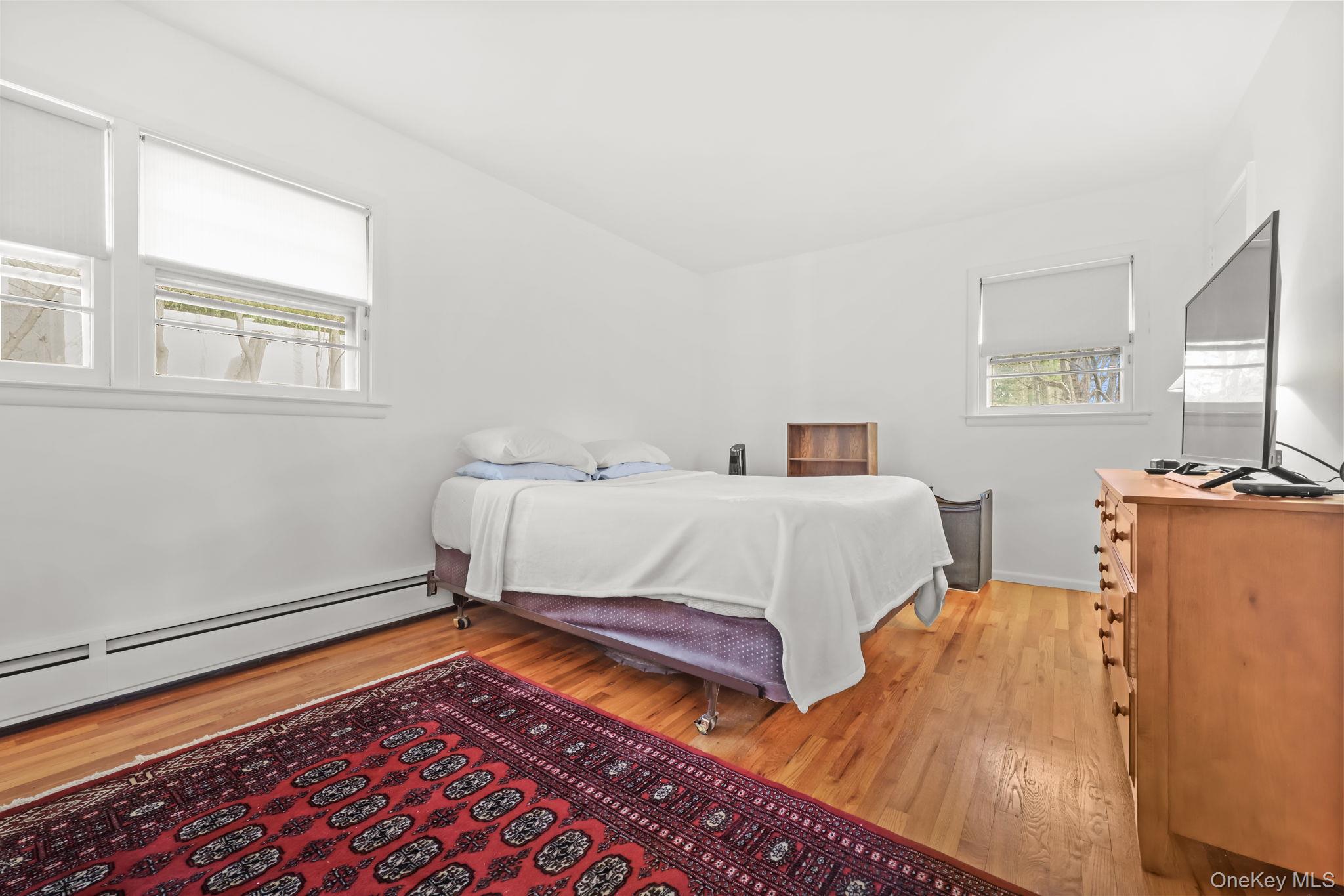 150 Rosedale Avenue White Plains, NY 10605 - Photo 18 of 42 a bedroom with a bed and wooden floor