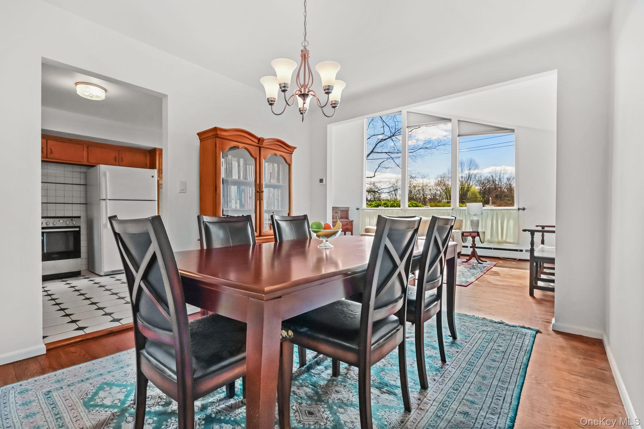 150 Rosedale Avenue White Plains, NY 10605 - Photo 9 of 42 a view of a dining room with furniture a chandelier and wooden floor