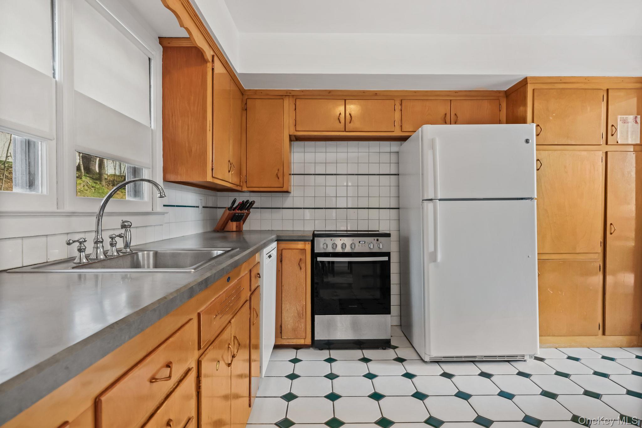 150 Rosedale Avenue White Plains, NY 10605 - Photo 10 of 42 a kitchen with sink a refrigerator and a stove top oven
