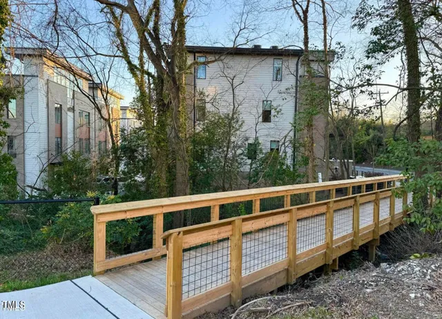 a view of a balcony with wooden fence