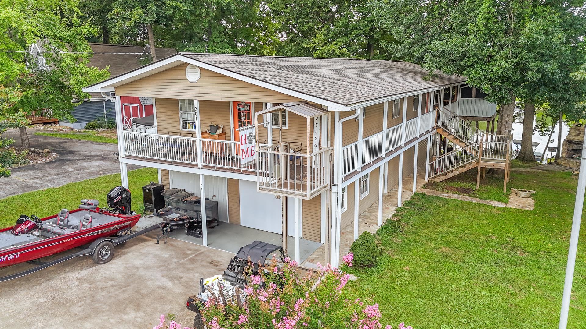 a view of a house with a yard and sitting area