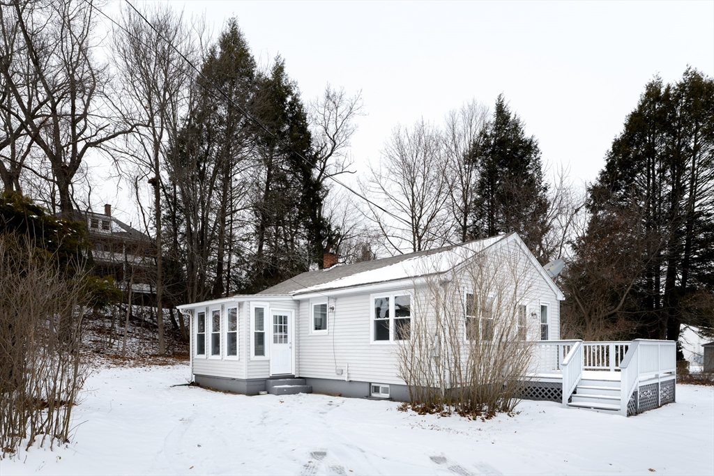 a view of a house with a yard covered in snow